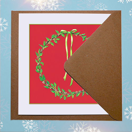 Original Christmas card featuring a traditional holly wreath with envelope