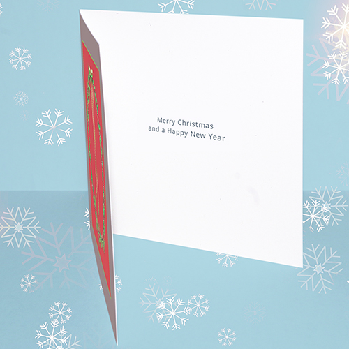 Inside of original Christmas card featuring a traditional holly wreath. Message inside reads 'Merry Christmas and a Happy New Year.'