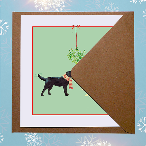 Front of original Christmas card design featuring a labrador dogs in Christmas scarves, with envelope