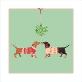 Front of original Christmas card design featuring two sausage dogs in Christmas jumpers under the mistletoe. Green background.