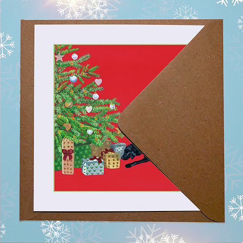 Original Christmas card design featuring a black labrador dog looking for her present with envelope
