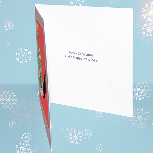 Inside of original Christmas card design featuring a black labrador dog looking for her present under the Christmas tree. Message reads 'Merry Christmas and a Happy New Year.'